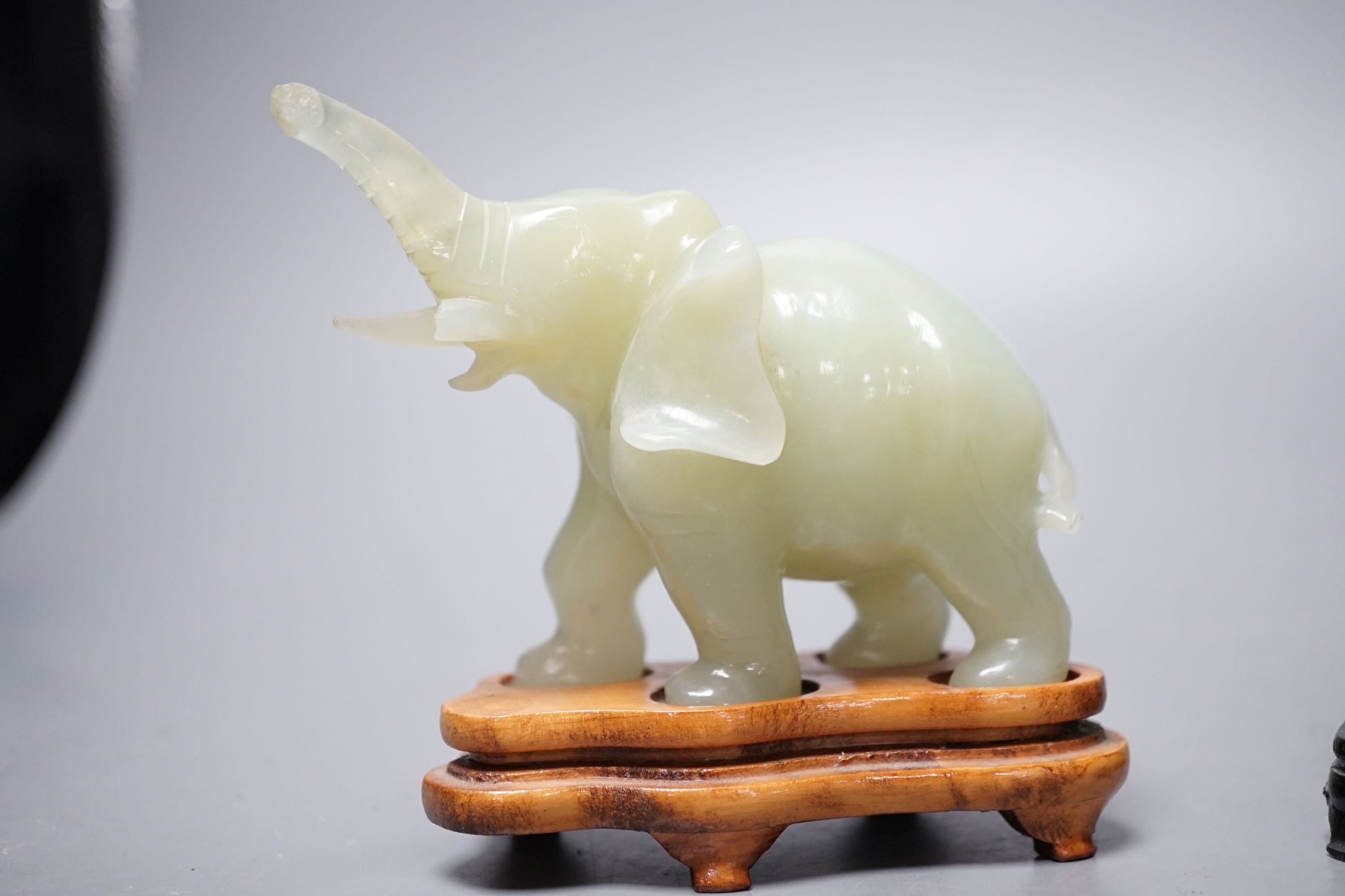 Two bowenite carvings of an elephant and Budai, wood stands, tallest, 9.5cm